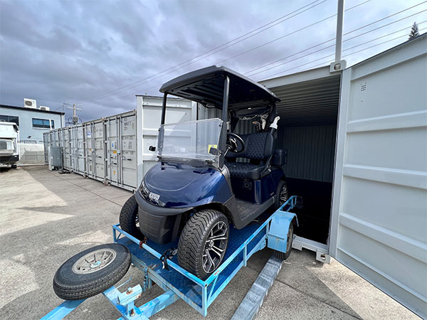 golf buggy being loaded inside of a 20ft storage container